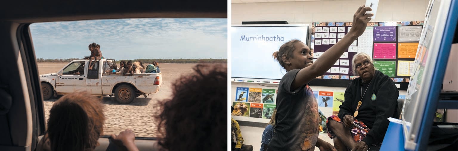 Photograph taken from a vehicle showing another vehicle filled with people driving through a barren landscape. A young girl and teacher in school setting.