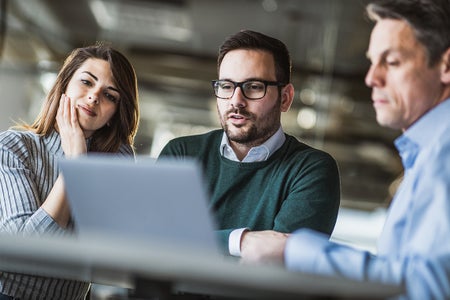 Three people in video meeting in the office