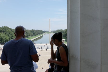 Two silhouetted figures at top of stairs
