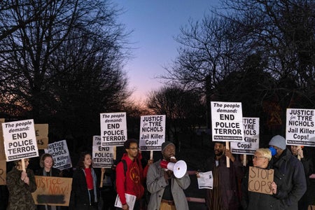 Protesters holding signs