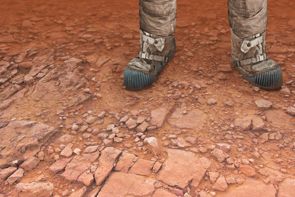An astronaut's booted foot close up, standing on Mars-red ground