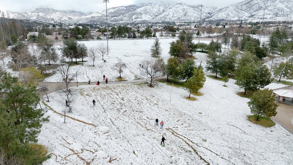 An aerial view of youth playing in the snow in Southern California.