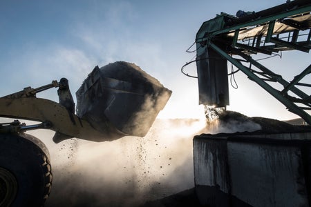 Steam rising from coal in morning light at surface coal mine