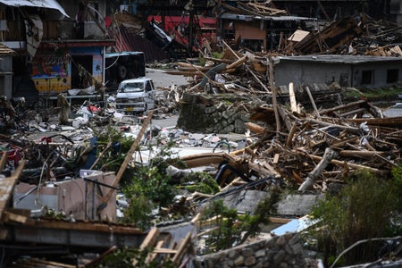 Heavy debris caused by flooding shown in the village of Kuma, Japan.