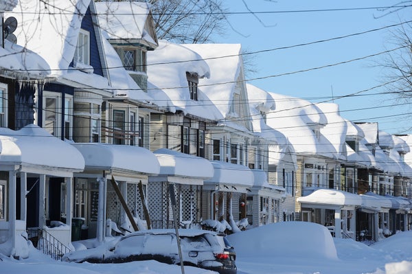 Houses and cars covered with snow