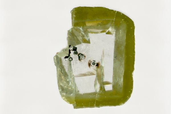 Mineral deposits in green-colored diamond.
