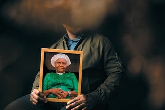 A family member holds a portrait of Iquo Edet Eyo, who was killed in Nigeria in October 2022.