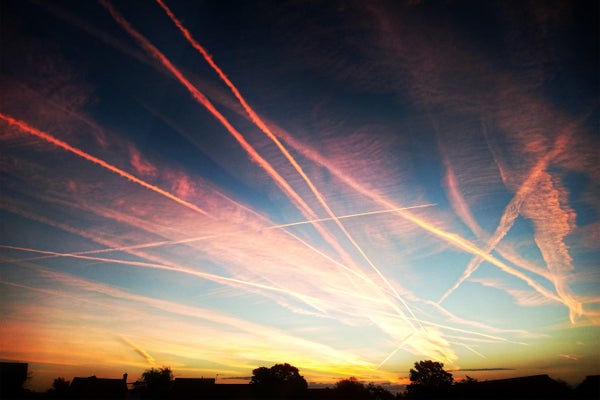 Vibrant sunset sky with lots of aeroplane contrails.