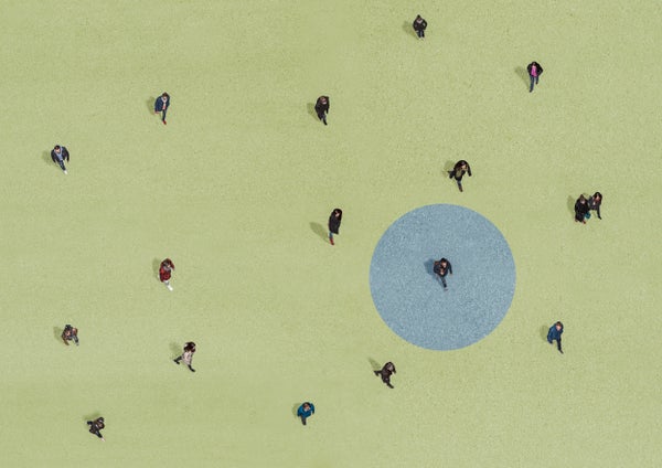 People seen walking from above at a distance, one person highlighted in a blue circle