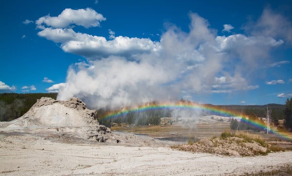 A rainbow beside a geyser in Yellowstone National Park, Wyoming.
