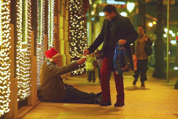 man giving money to homeless