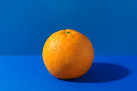 An orange citrus fruit on a blue background