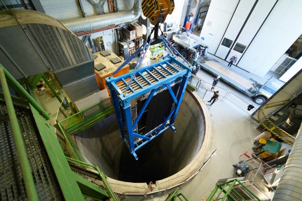 Workers install an upgrade to the LHCb detector.