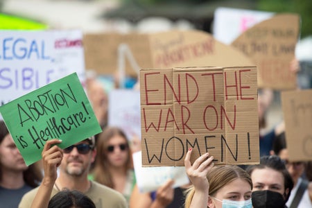 Abortion rights protesters holding signs outside of the Texas State Capital in 2022.