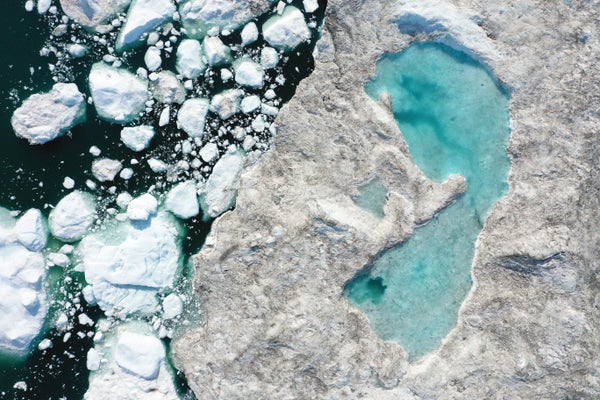 Aerial view of melting ice forming a lake on free-floating ice jammed into the Ilulissat Icefjord.