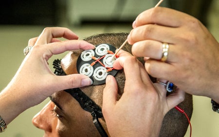 Electrodes to administer directed electrical brain stimulation placed on the head of a test subject.