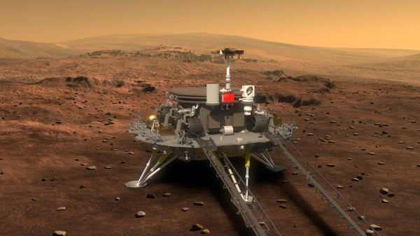 The illustration shows a gray lander and rover sitting on the red Martian surface.