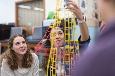 Teacher shows her class a colorful example of sculpture