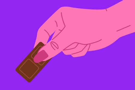 A woman's hand reaching for some chocolate. Her hand is an exaggerated pink against a bright purple background