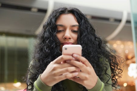 Young woman texting on smartphone