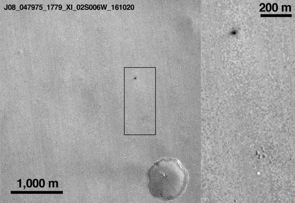 A satellite image revealing the Schiaparelli lander's crater on Mars