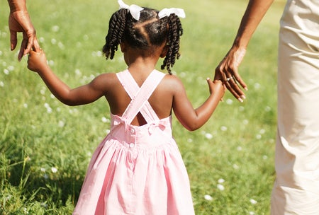 toddler holding parents hands