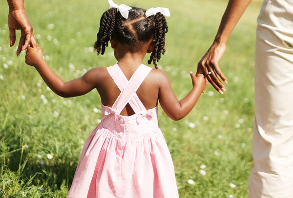 toddler holding parents hands