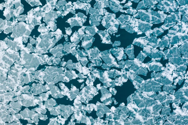 Aerial view of blue and white sea ice chunks in Borebukta Bay, Norway