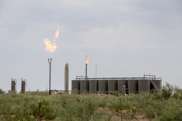 Industrial landscape with methane gas flare.