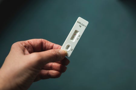 Hand of woman holding rapid diagnostic test for COVID-19