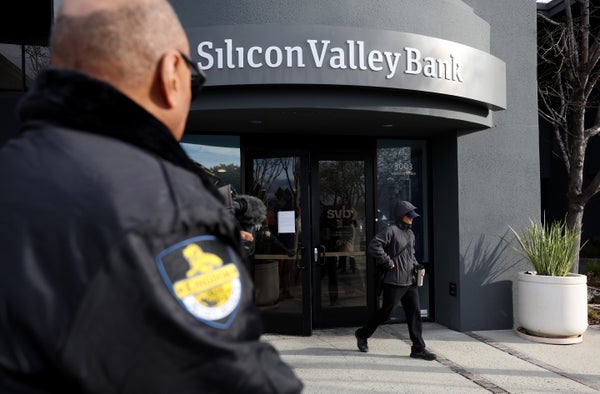 A security guard watches a customer leave a Silicon Valley Bank office.