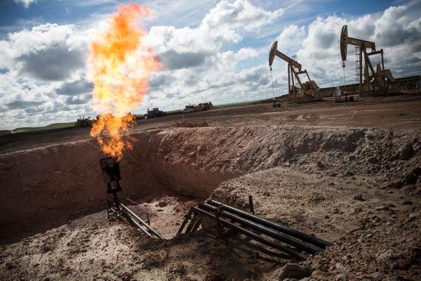 A gas flare is seen at an oil well site.