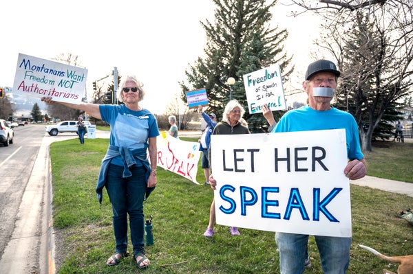 Sign held by supporter reads, "LET HER SPEAK"