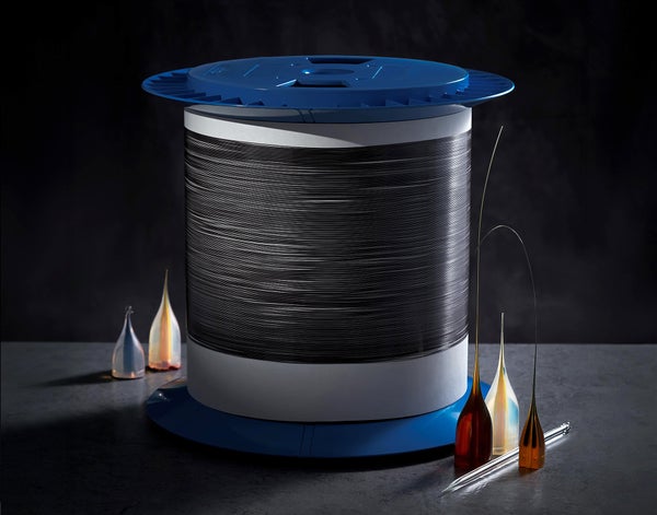 A table displaying a spool of black thread