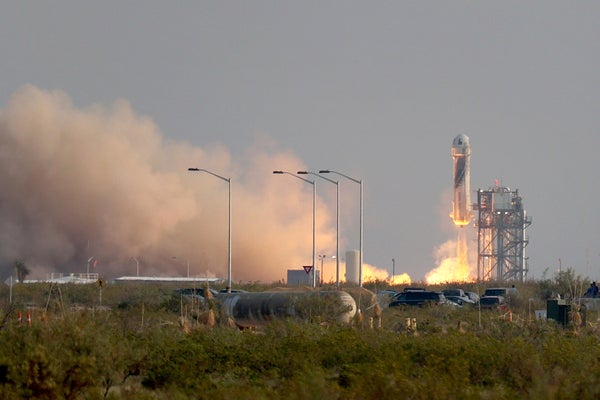 The New Shepard Blue Origin rocket lifts-off from the launch pad.