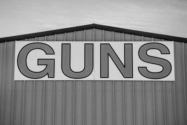 GUNS sign on gun store.