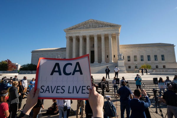 ACA SAVEL LIVES sign held up in front of Supreme Court D.C.