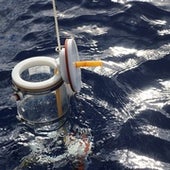 Point water sampler being lowered into the Pacific Ocean to 200 meters to collect a water sample deep in the water column.