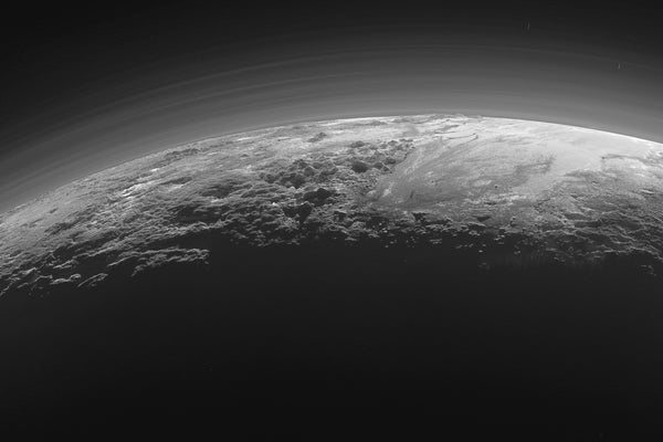 View of Pluto horizon, smooth expanse of the informally named icy plain Sputnik Planum (right) flanked to the west (left) by rugged mountains up to 11,000 feet high.Backlighting highlights more than a dozen layers of haze in Pluto's atmosphere
