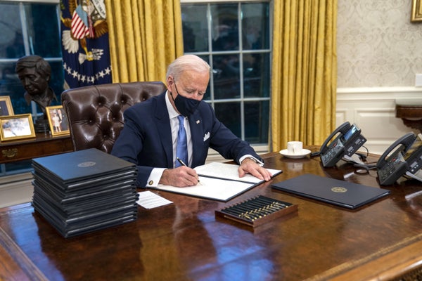 oe Biden signs executive orders in the Oval Office of the White House in Washington, D.C., U.S., on Wednesday, Jan. 20, 2021.
