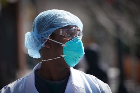 Portrait of a medical worker with protective gear and mask.