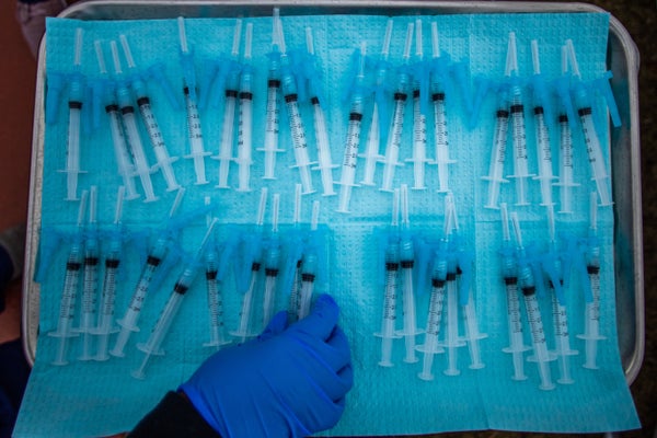 A nurse takes a Moderna Covid-19 vaccines ready to be administered at a vaccination site