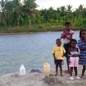 YOUNG WATER COLLECTORS AT A RIVER IN HAITI