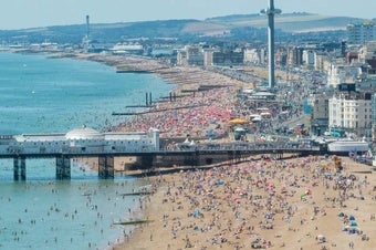 Beachgoers crowd the seashore in Brighton, England, in July 2022