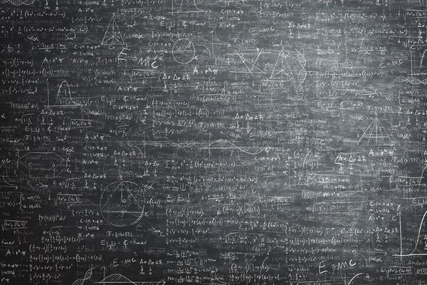 A chalkboard covered with complicated equations and diagrams.