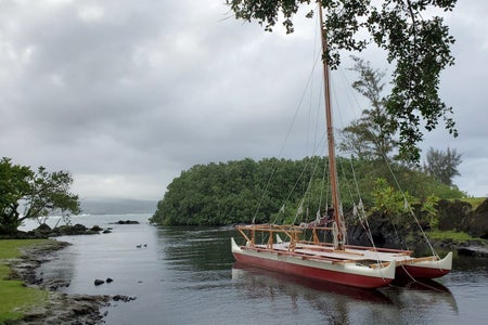 Hawaiian boat under cloudy skies.