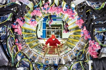 A technician installs cables on the new sPHENIX detector at the Relativistic Heavy Ion Collider