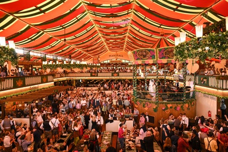 An overview of revelers indoors at Oktoberfest.