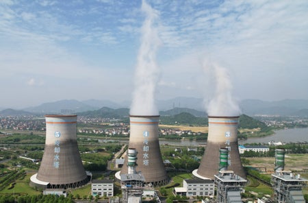 Coal-fired power plant billowing smoke.