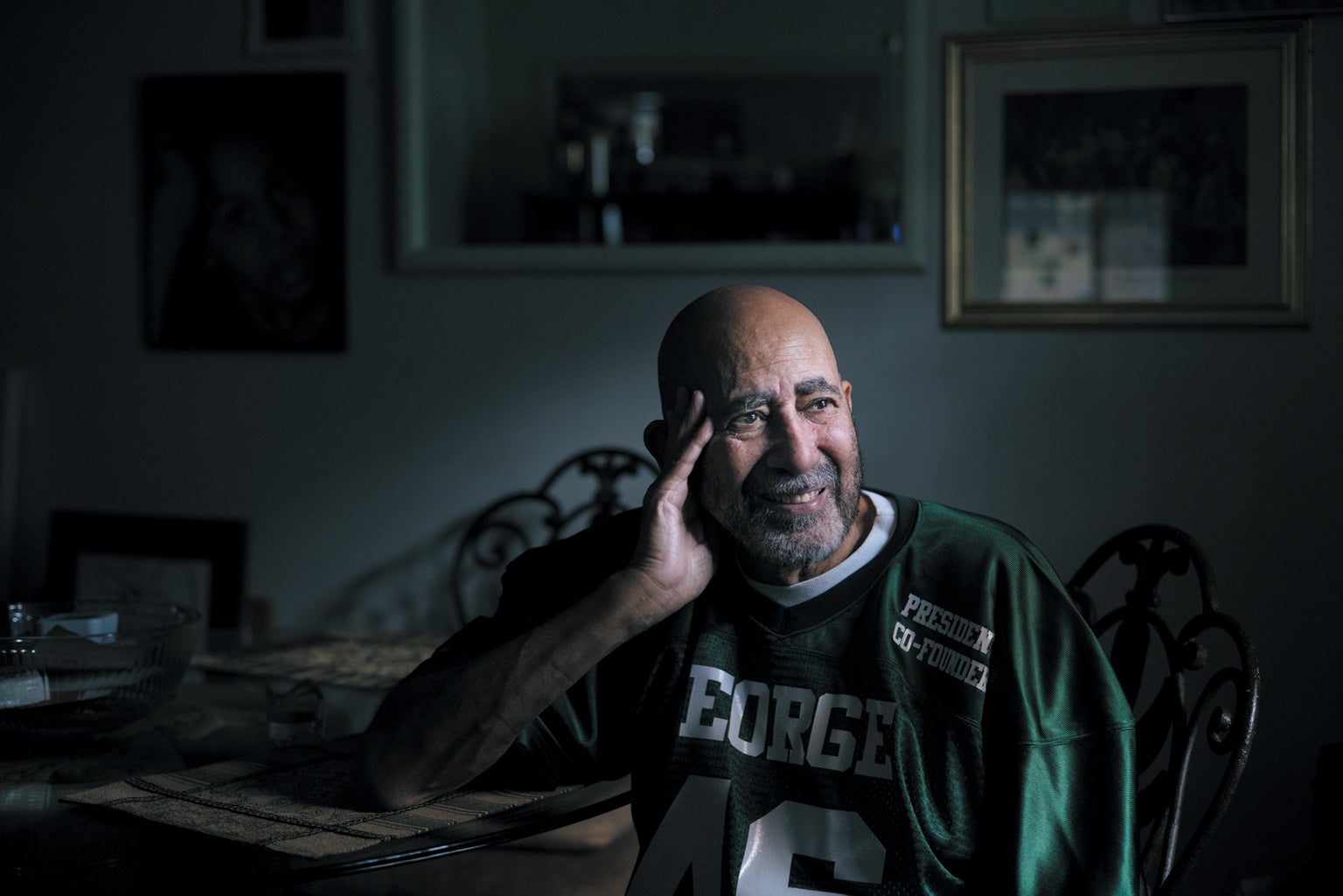 Man sitting on a chair, smiling. 